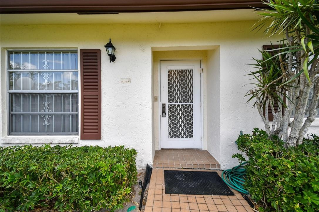 5348 Privet Place, Unit D Delray Beach, FL 33484 - Photo 3 of 60 a view of a house with a yard