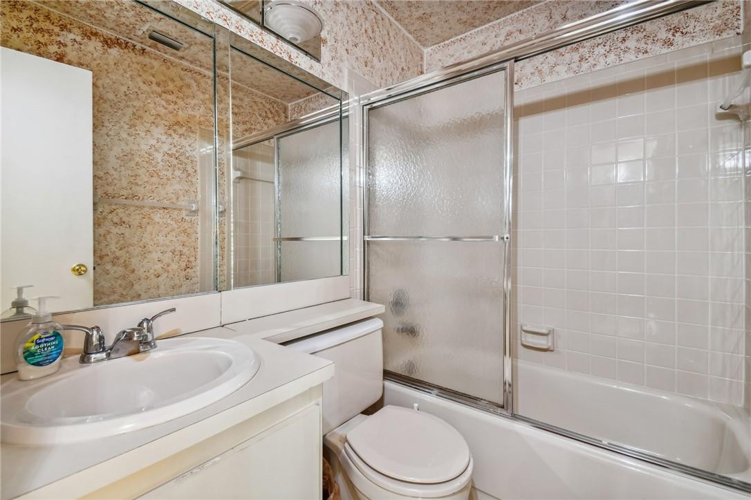 5348 Privet Place, Unit D Delray Beach, FL 33484 - Photo 35 of 60 a bathroom with a sink toilet and shower