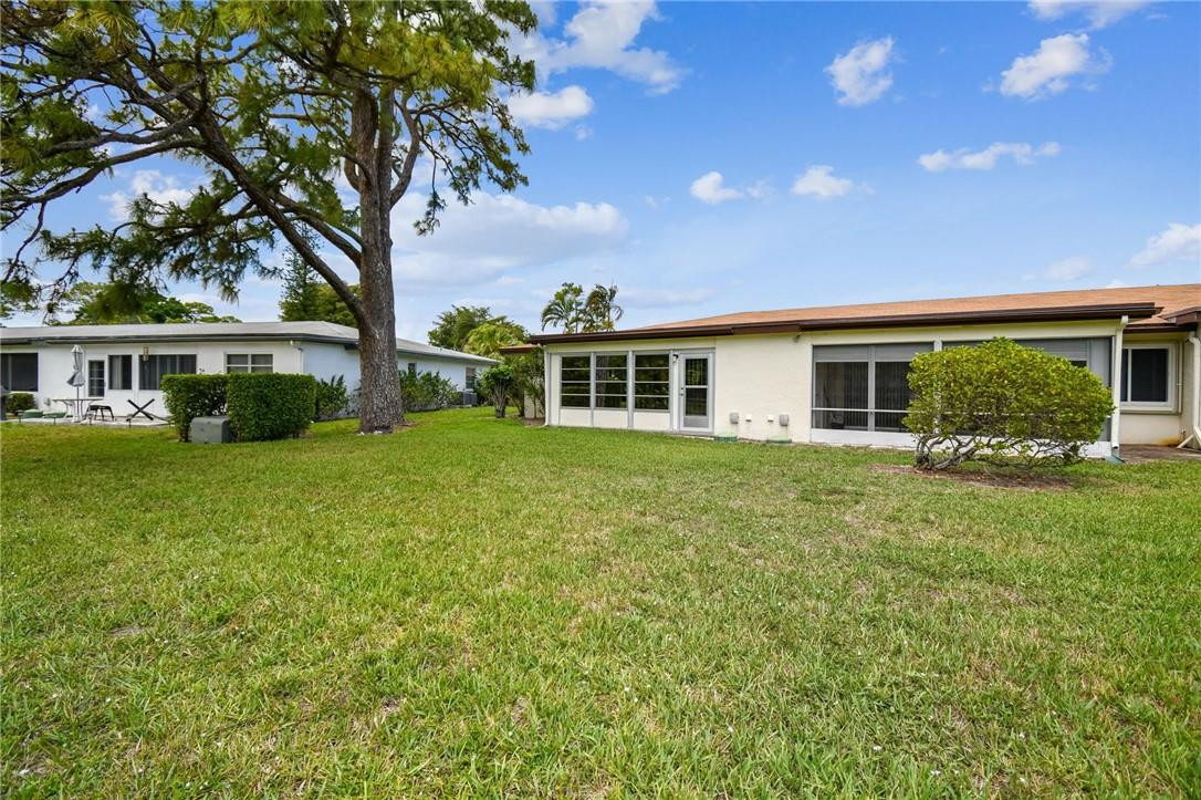 5348 Privet Place, Unit D Delray Beach, FL 33484 - Photo 43 of 60 a front view of a house with a yard
