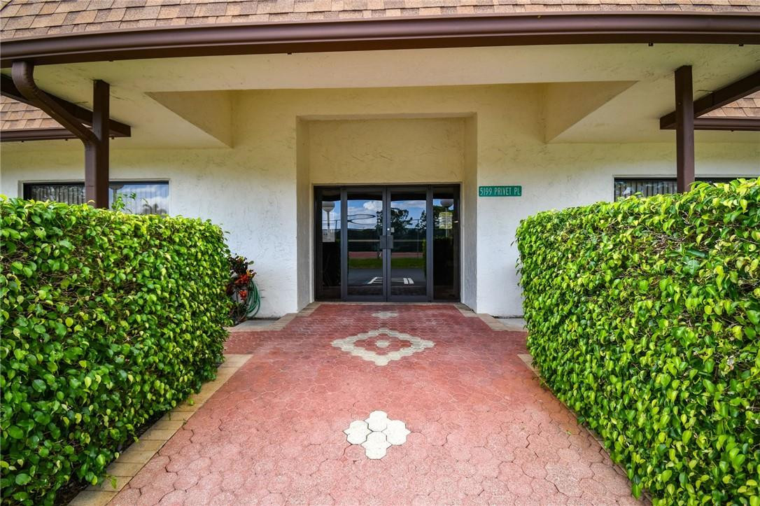 5348 Privet Place, Unit D Delray Beach, FL 33484 - Photo 52 of 60 a front view of a house with a yard