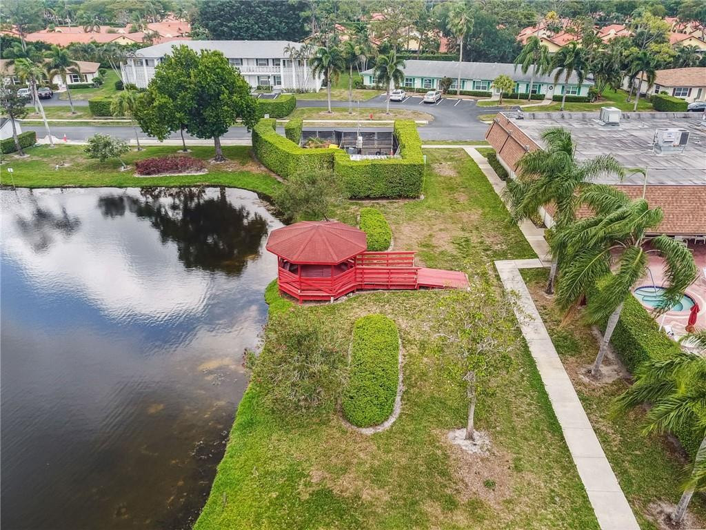 5348 Privet Place, Unit D Delray Beach, FL 33484 - Photo 58 of 60 a view of a swimming pool with a patio