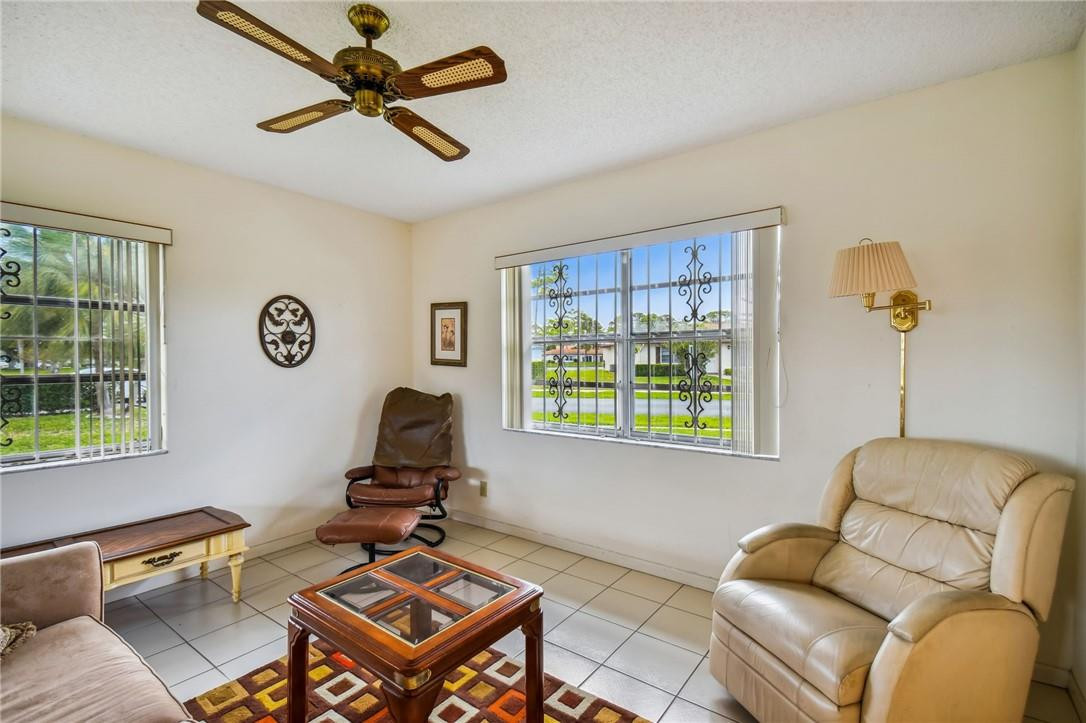 5348 Privet Place, Unit D Delray Beach, FL 33484 - Photo 6 of 60 a living room with furniture a window and a chandelier