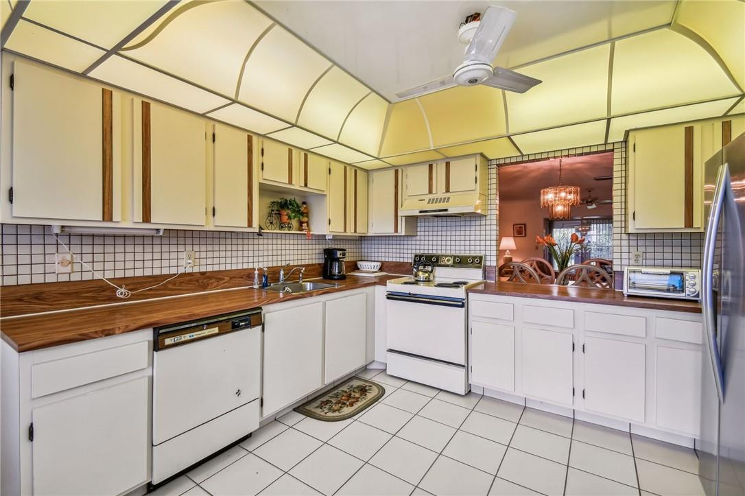 5348 Privet Place, Unit D Delray Beach, FL 33484 - Photo 10 of 60 a kitchen with stainless steel appliances white cabinets and a sink