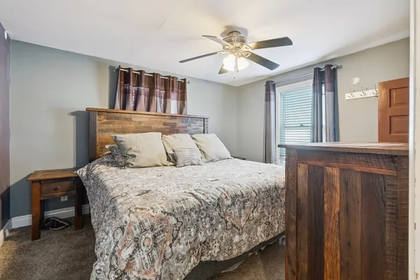 a bedroom with a large bed and a chandelier