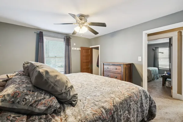 a bedroom with a bed and a chandelier