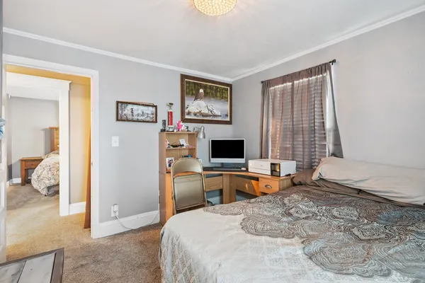 a bedroom with a bed and a television