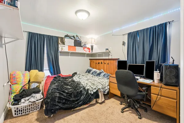 a bedroom with a bed and a desk