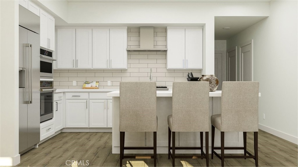 2209 Rivington Irvine, CA 92612 - Photo 1 of 20 a white kitchen with cabinets and chairs