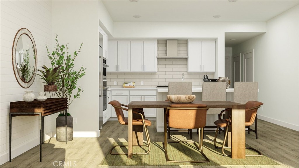 2209 Rivington Irvine, CA 92612 - Photo 4 of 20 a kitchen with granite countertop a table chairs stove and cabinets