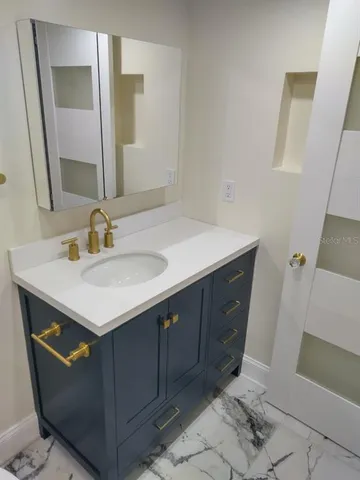 a bathroom with a sink and a mirror
