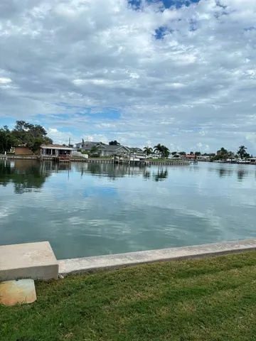 a view of a lake with houses in the back