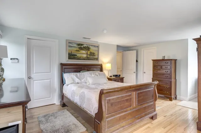 a bedroom with a bed and a dresser