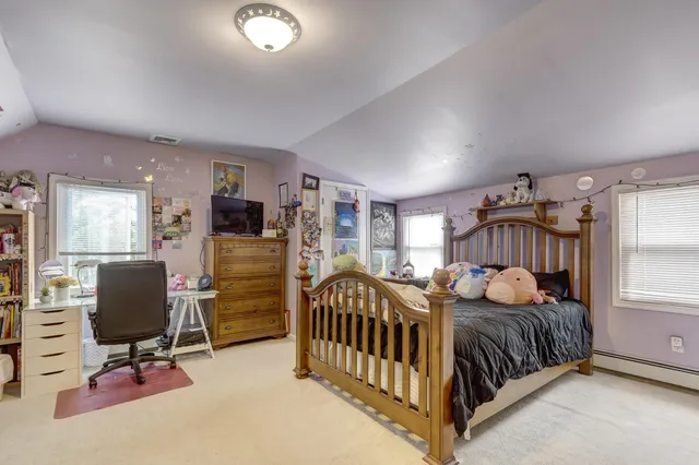 a bedroom with furniture and a window