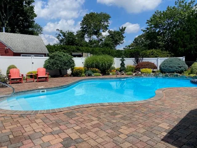 a view of a house with swimming pool and sitting area