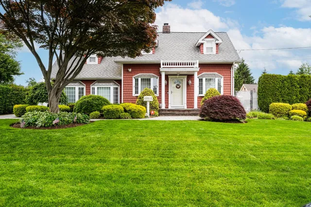a front view of a house with garden