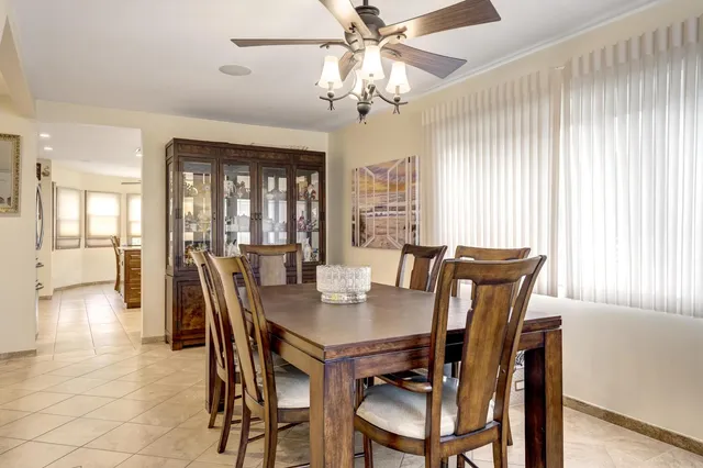 a view of a dining room with furniture and a chandelier