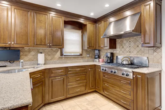 a kitchen with a sink stove and cabinets