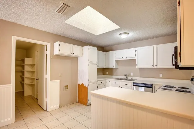 a kitchen with stainless steel appliances a refrigerator sink and cabinets