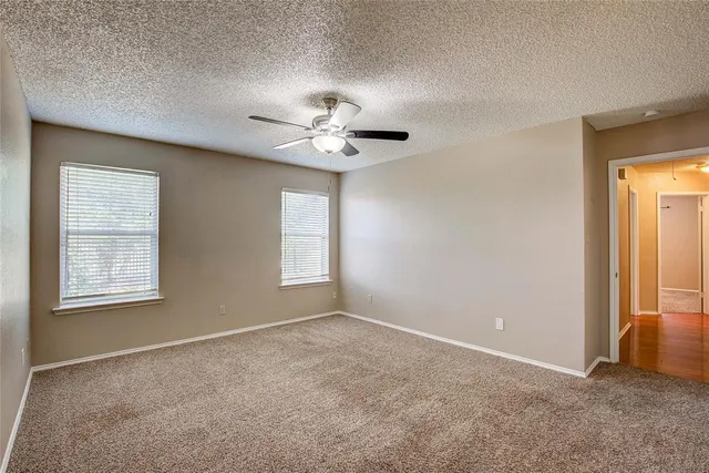 an empty room with windows and closet