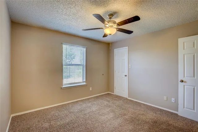 a view of a livingroom with a ceiling fan and window