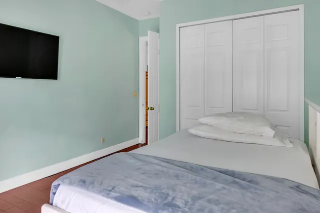 a bedroom with a bed and a flat screen tv