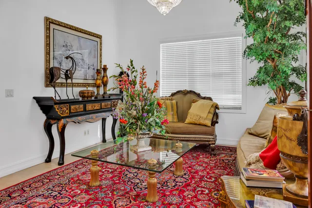 a living room with furniture and a potted plant