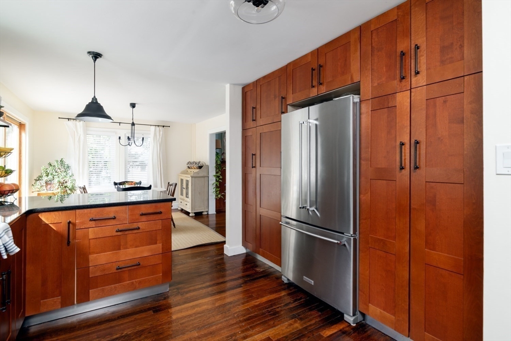 501 Spring Street Hanson, MA 02341 - Photo 7 of 32 a kitchen with stainless steel appliances granite countertop a refrigerator a oven and a sink with wooden floors