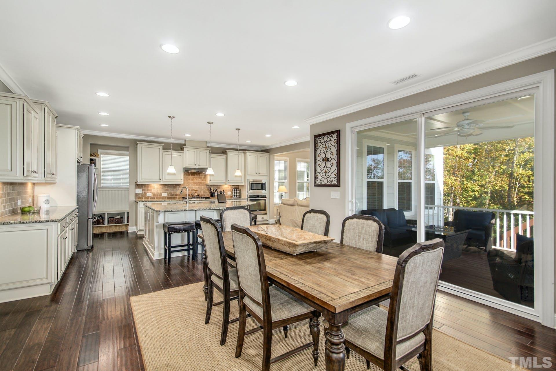 2013 White Rocks Road Wake Forest, NC 27587 - Photo 11 of 36 a dining room with stainless steel appliances granite countertop a table chairs and a living room view