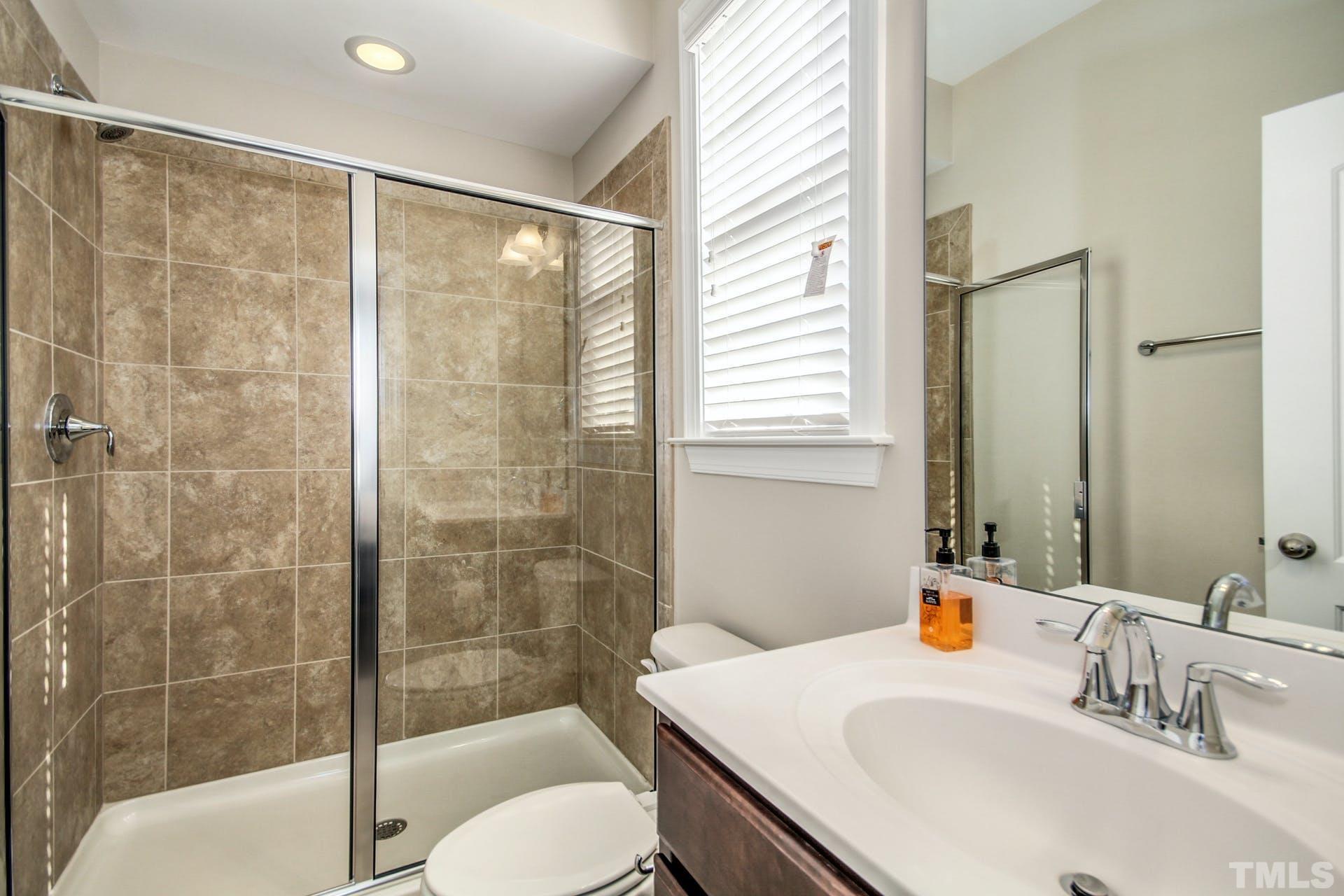 2013 White Rocks Road Wake Forest, NC 27587 - Photo 15 of 36 a bathroom with a sink toilet and shower