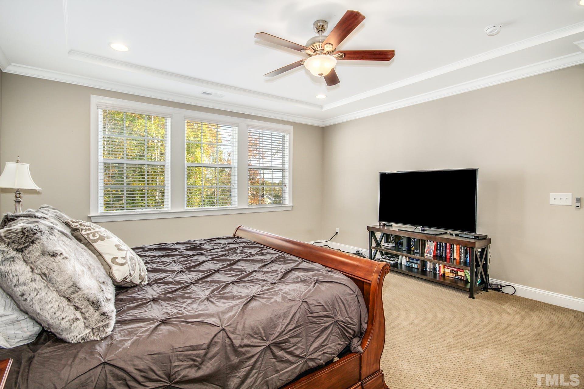 2013 White Rocks Road Wake Forest, NC 27587 - Photo 16 of 36 a bedroom with a bed and a flat screen tv