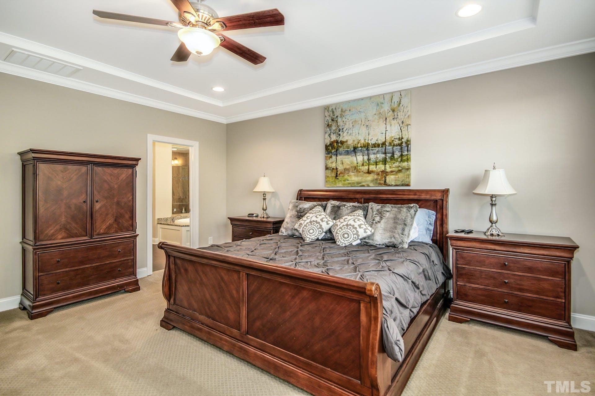 2013 White Rocks Road Wake Forest, NC 27587 - Photo 18 of 36 a bedroom with a bed and a chandelier