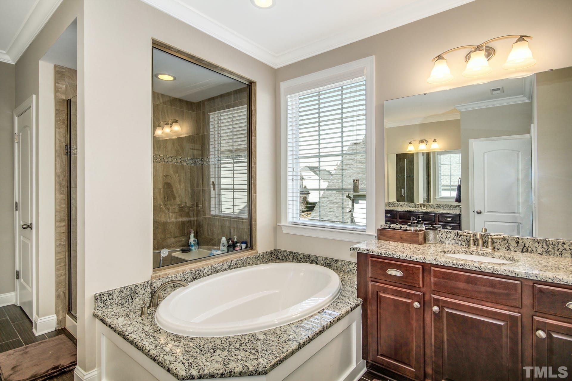 2013 White Rocks Road Wake Forest, NC 27587 - Photo 19 of 36 a bathroom with a granite countertop sink and a mirror
