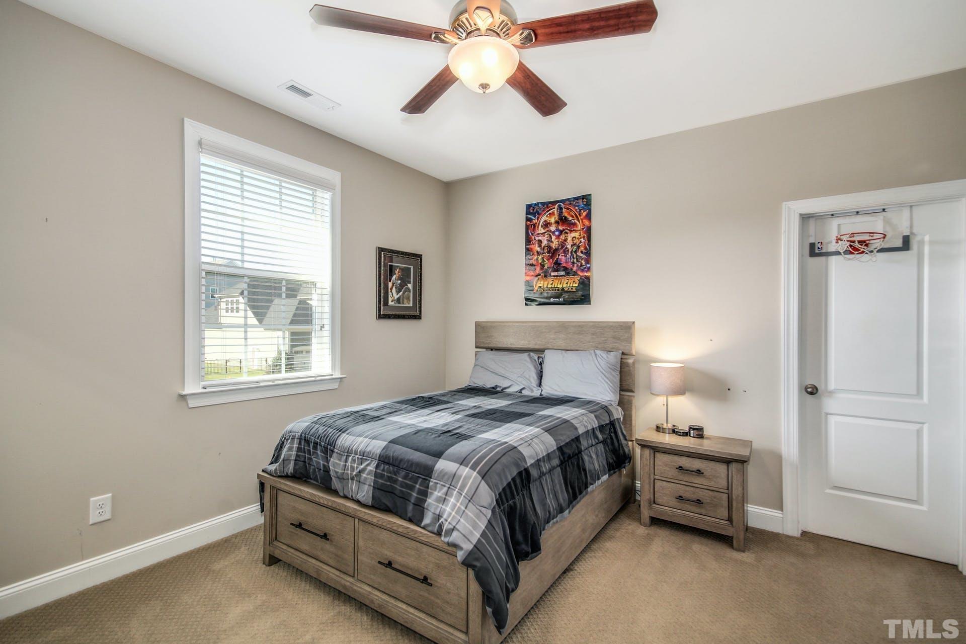 2013 White Rocks Road Wake Forest, NC 27587 - Photo 24 of 36 a bedroom with a bed and a chandelier