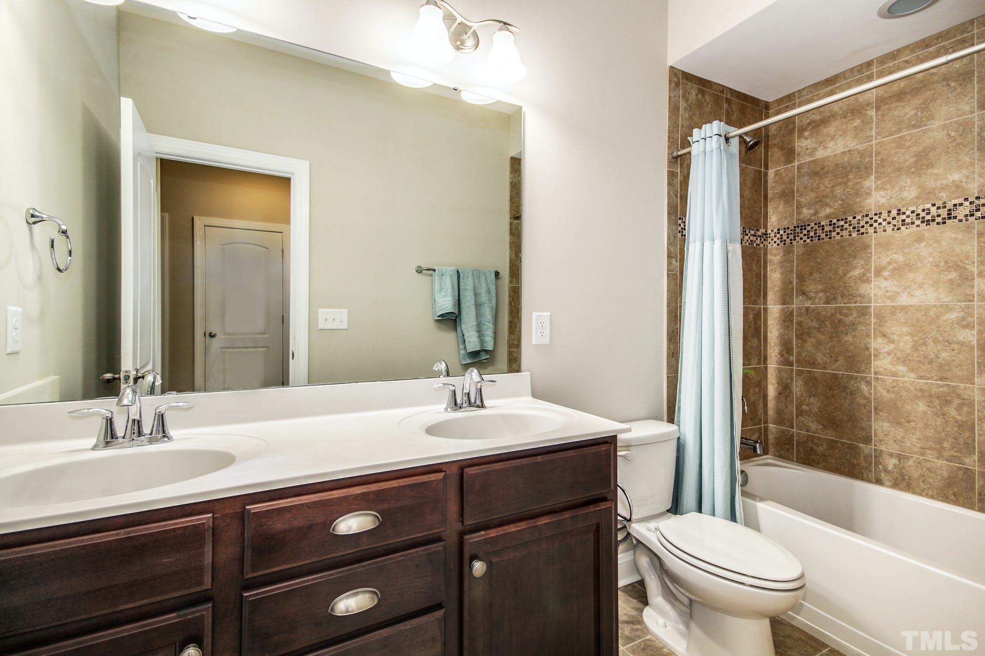2013 White Rocks Road Wake Forest, NC 27587 - Photo 27 of 36 a bathroom with a sink a toilet and shower
