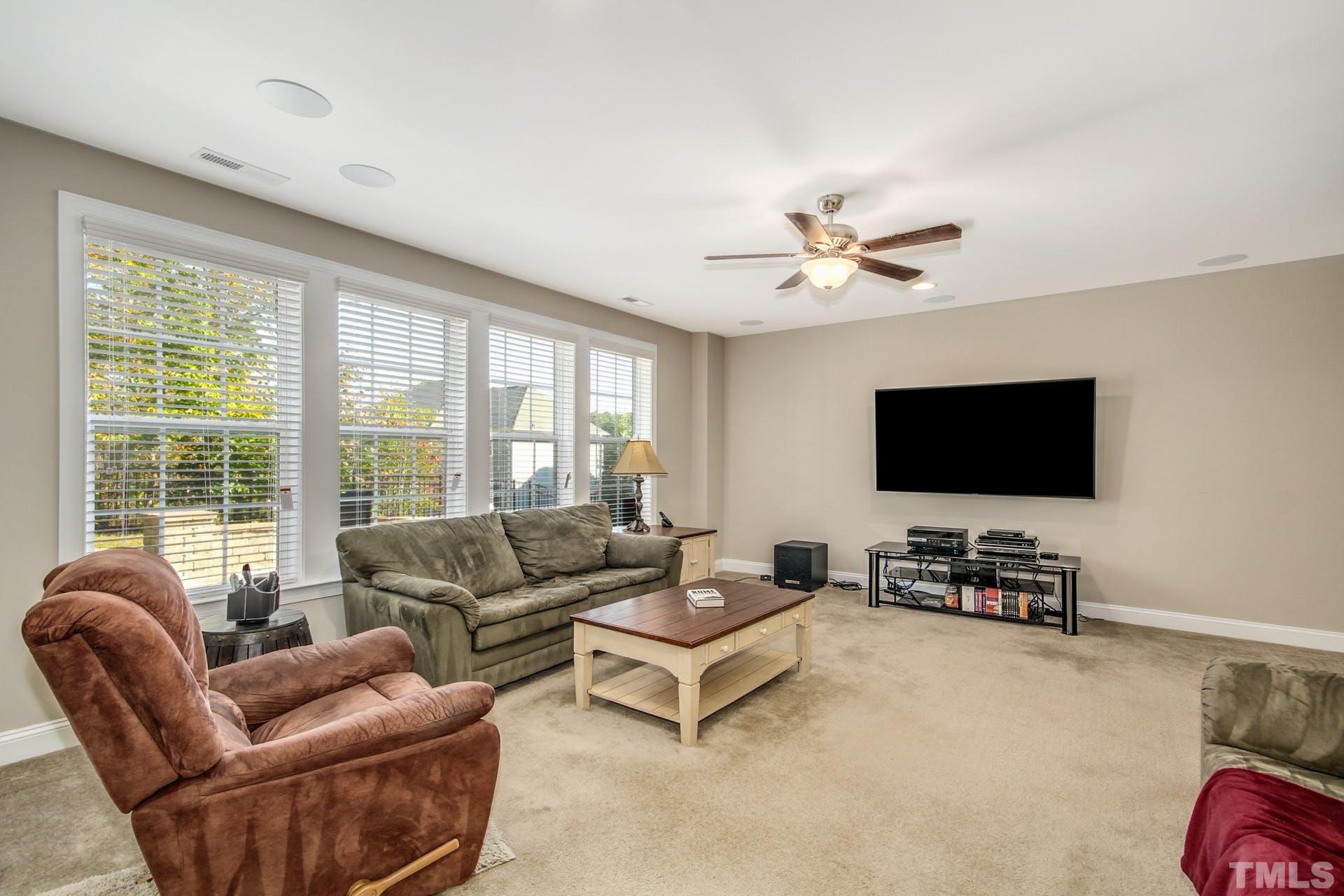 2013 White Rocks Road Wake Forest, NC 27587 - Photo 28 of 36 a living room with furniture and a flat screen tv