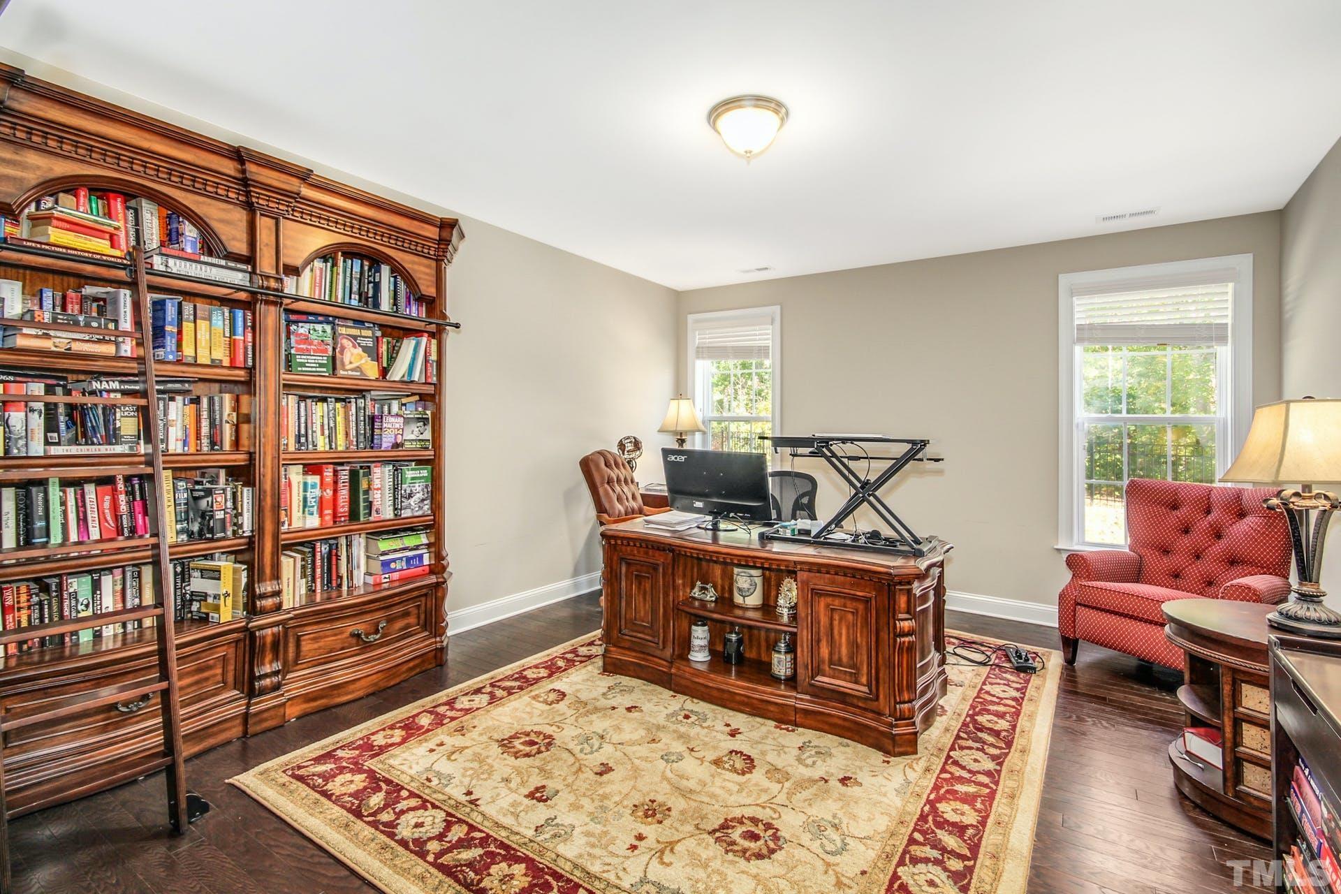 2013 White Rocks Road Wake Forest, NC 27587 - Photo 32 of 36 a living room with furniture and a book shelf