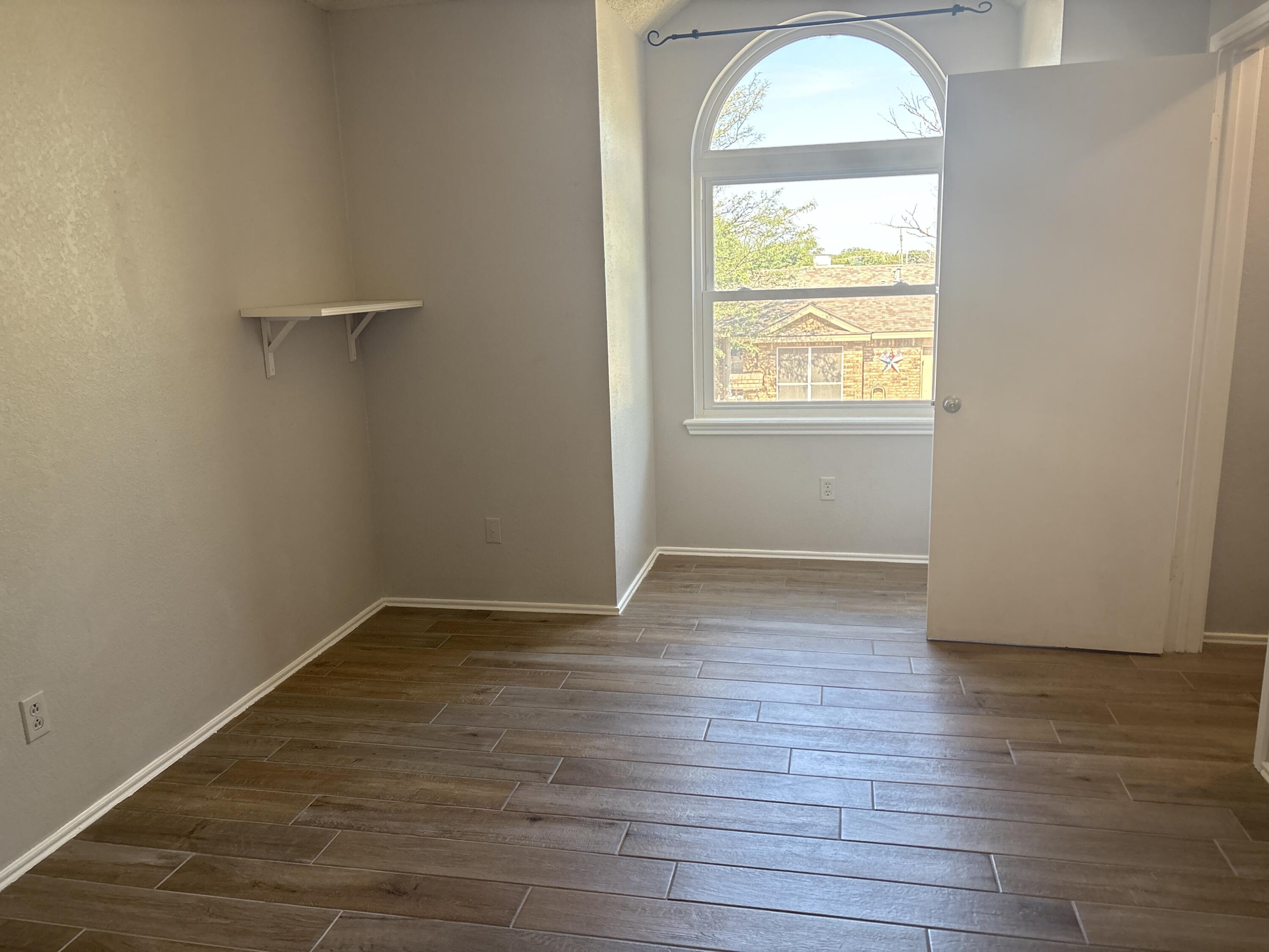 3421 Hyden Avenue Lubbock, TX 79407 - Photo 15 of 18 a view of empty room with wooden floor and fan
