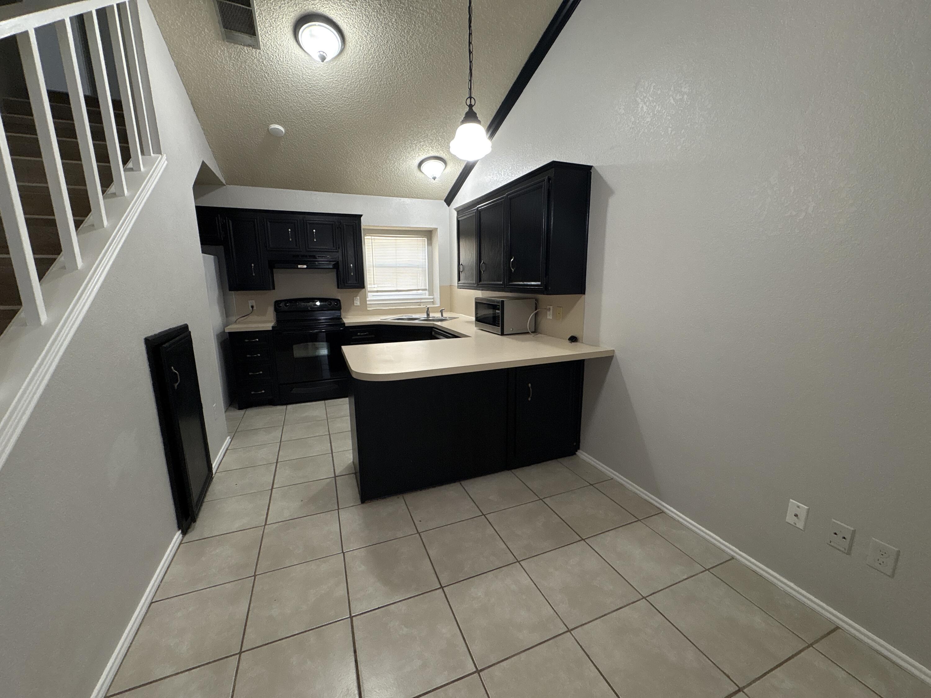 3421 Hyden Avenue Lubbock, TX 79407 - Photo 5 of 18 a kitchen with a sink a counter top space cabinets and stainless steel appliances