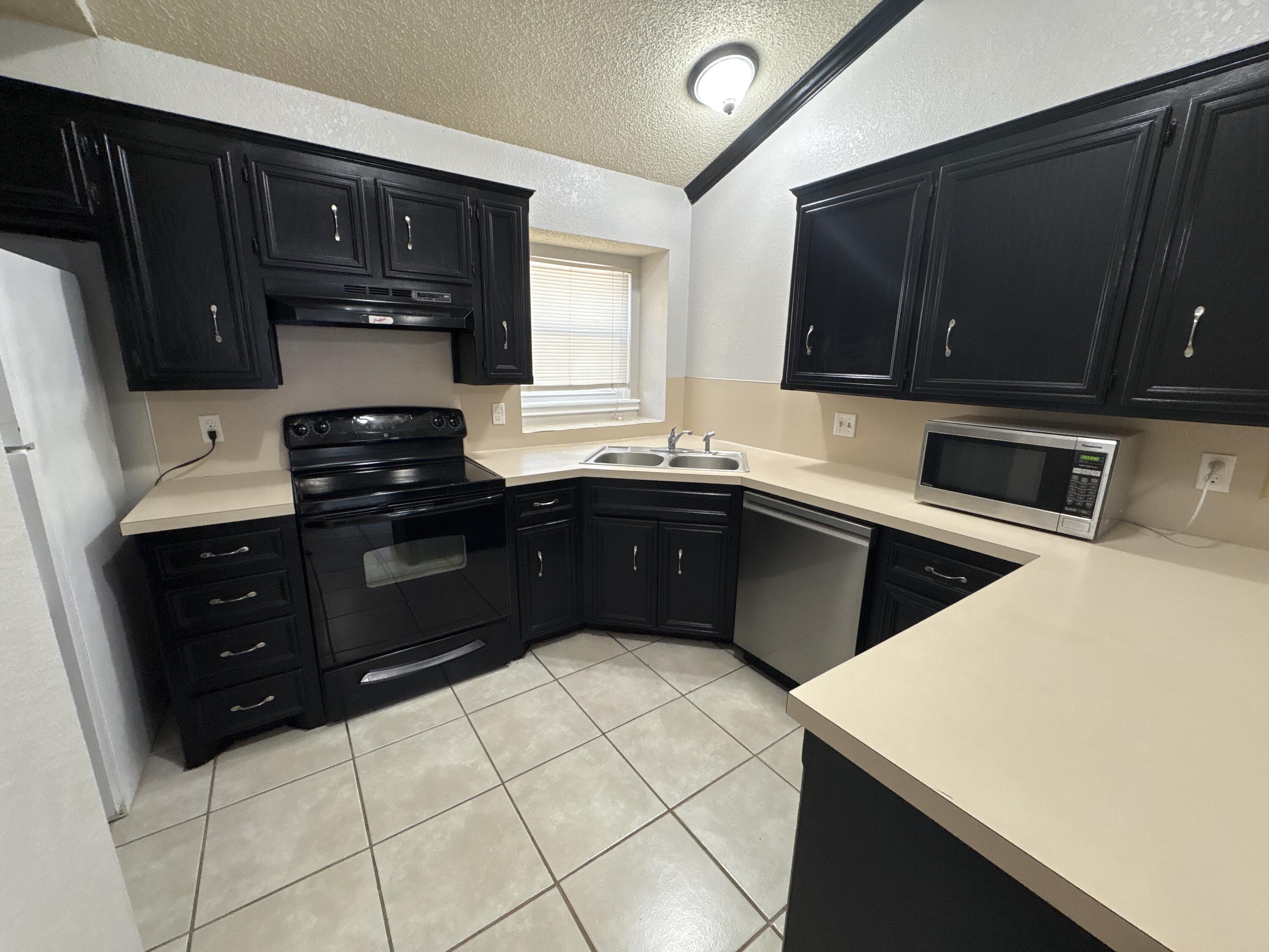 3421 Hyden Avenue Lubbock, TX 79407 - Photo 7 of 18 a kitchen with a sink and a stove