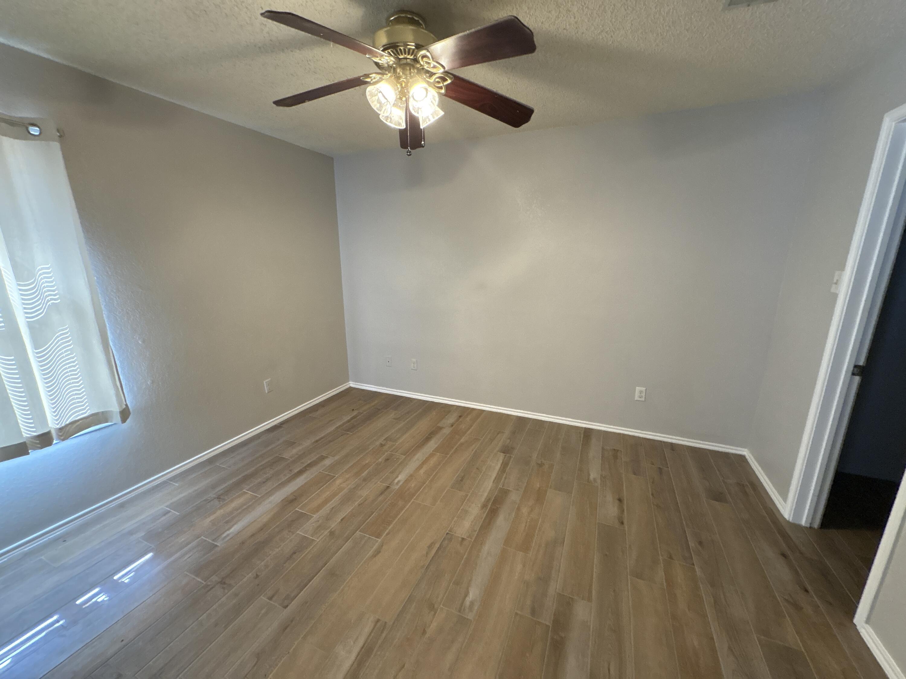 3421 Hyden Avenue Lubbock, TX 79407 - Photo 9 of 18 wooden floor in an empty room with a window