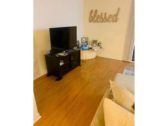 2104 Spring Forest Road, Unit 2104 Raleigh, NC 27615 - Photo 7 of 9 a living room with a flat screen tv and furniture