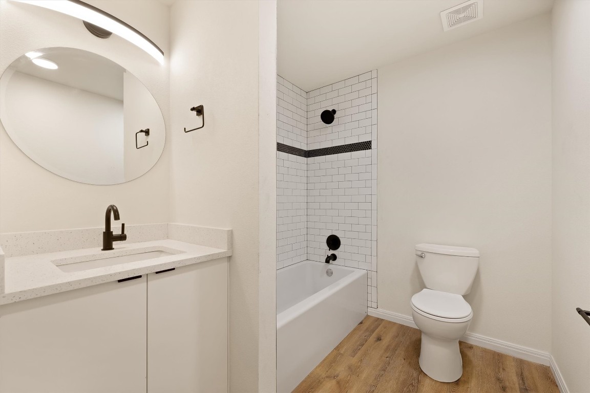 313 Mill Street San Marcos, TX 78666 - Photo 9 of 11 a bathroom with a toilet a sink and mirror