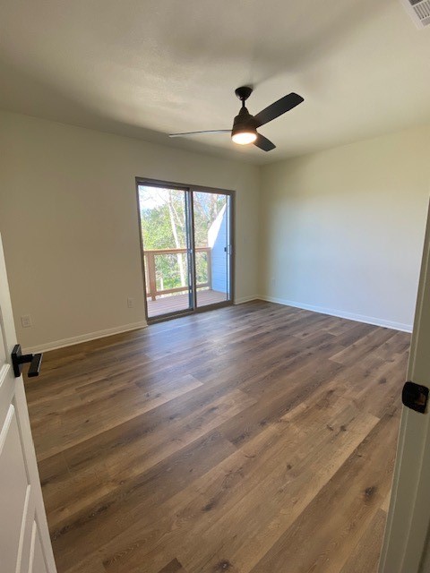 313 Mill Street San Marcos, TX 78666 - Photo 10 of 11 an empty room with wooden floor fan and windows