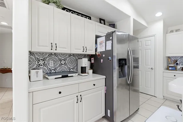 a kitchen with stainless steel appliances kitchen island granite countertop a refrigerator and a stove top oven