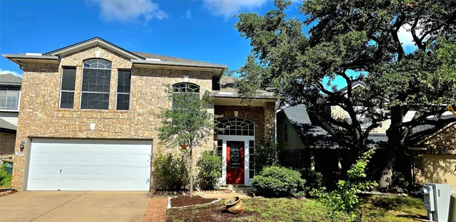 a front view of a house with yard