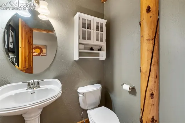 a bathroom with a toilet sink and mirror