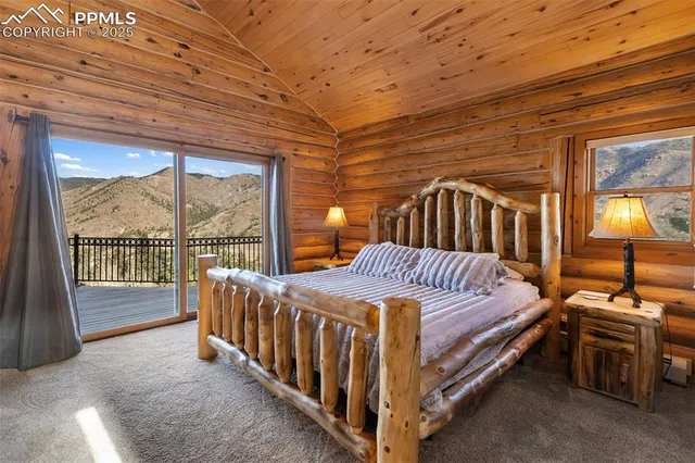 a bedroom with a bed next to a large window