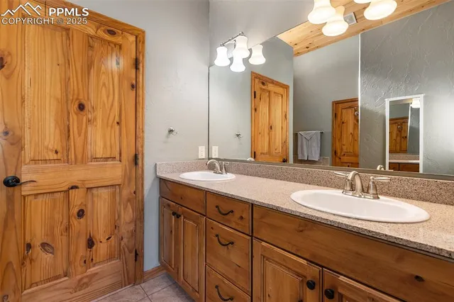 a bathroom with a double vanity sink and a mirror