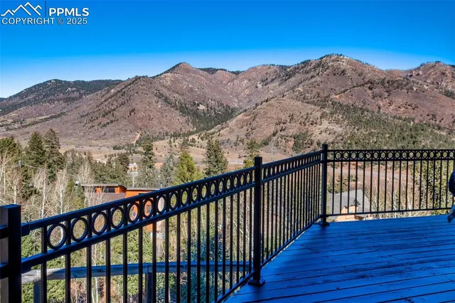 a balcony with view of mountains in the background