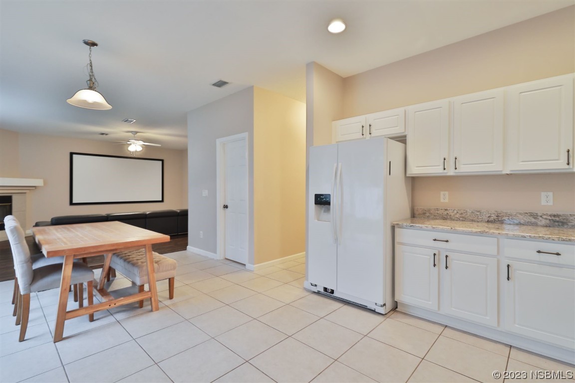 1922 Cove Point Road Port Orange, FL 32128 - Photo 13 of 54 a kitchen with granite countertop cabinets and refrigerator